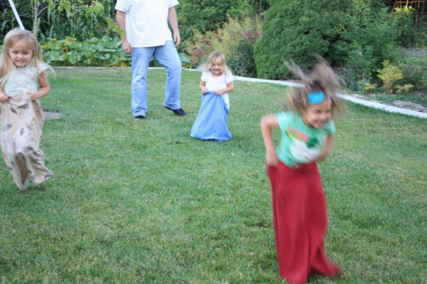 Kids jumping in pillow sacks for exercise.