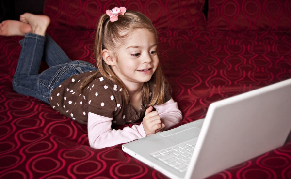 Kid typing on computer